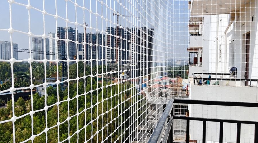 ENB Enterprises team installing bird protection nets on apartment balcony in Chennai