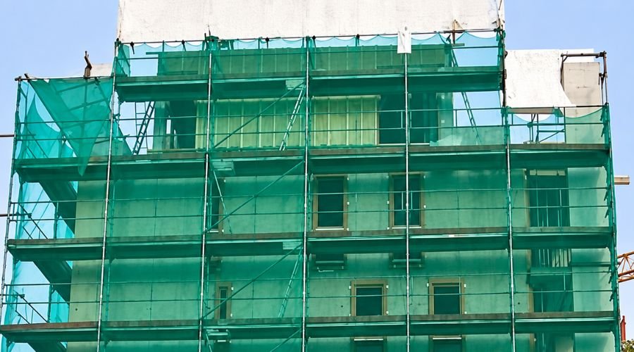 Construction safety nets covering the exterior of a multi-storey building in Chennai